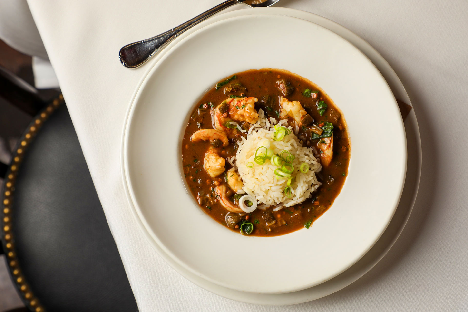 Shrimp and okra gumbo laced with collard greens on top of Louisiana popcorn rice. © Randy Krause Schmidt/La Petite Grocery