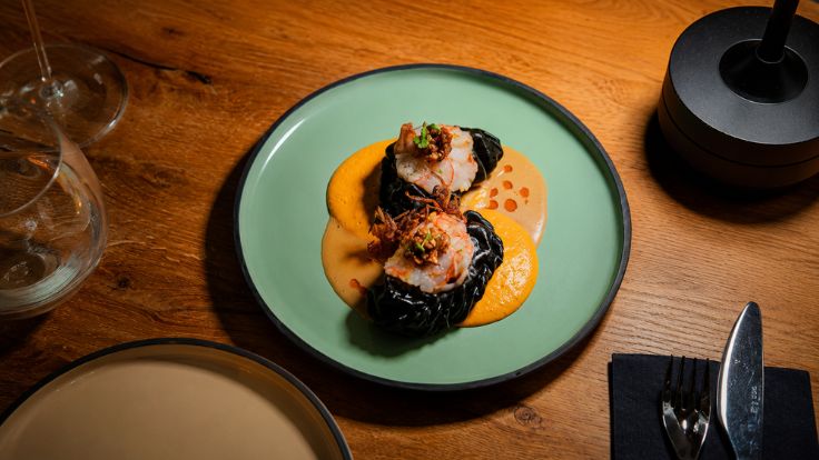 Pork and shrimp dumplings, served with hazelnut-infused carrot foam and lobster bisque sauce. © B’ARN Bistro