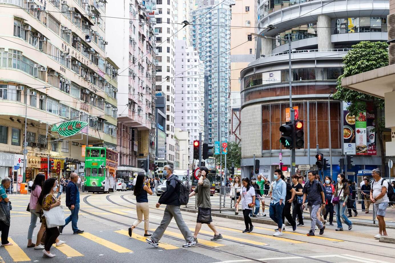 Nearly 600,000 people pass through Wan Chai each day, shaping its ever-changing rhythm of life and dining. © Shutterstock 