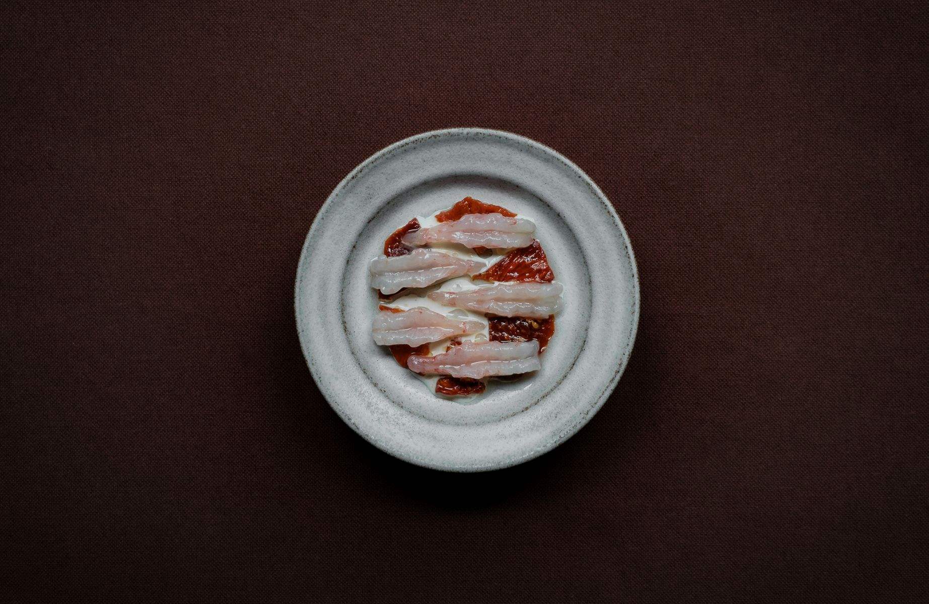 Raw Norwegian shrimps with preserved tomatoes at Kadeau Copenhagen . © Soren Kristian Reed/Kadeau Copenhagen