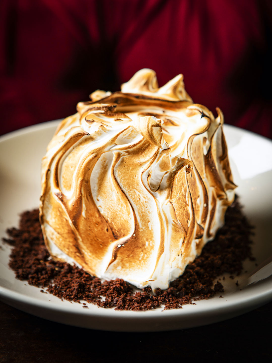 Baked Alaska filled with layers of fresh mint, dark chocolate and Amarena cherry ice creams tucked between chocolate cookie crunch and finished with a crown of toasted Swiss meringue. © Lizzie Munro/Gage & Tollner