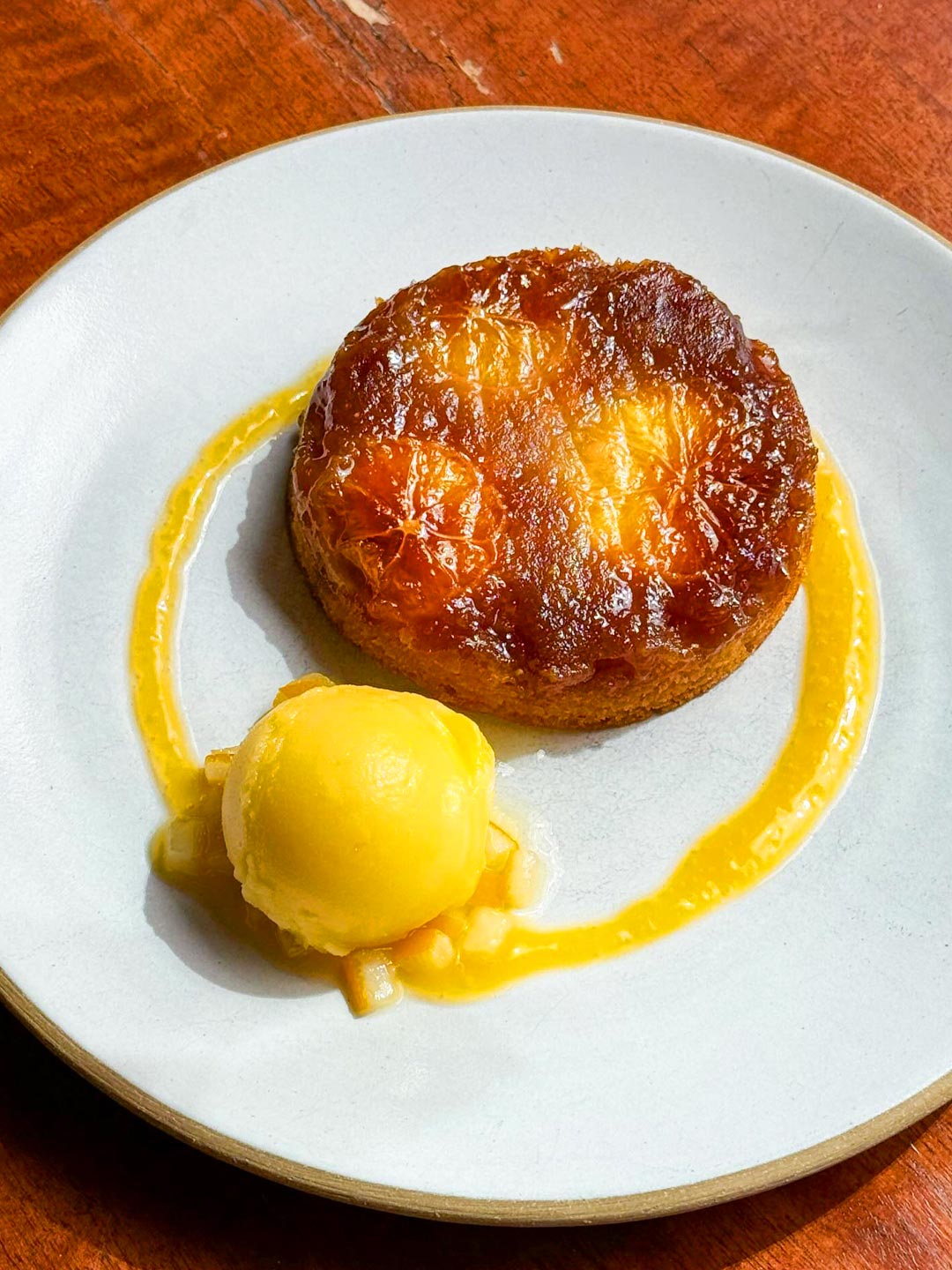 Citrus upside-down Cake with Meyer lemon, cara cara oranges and brown sugar is served warm with Meyer lemon sorbet. © Gramercy Tavern