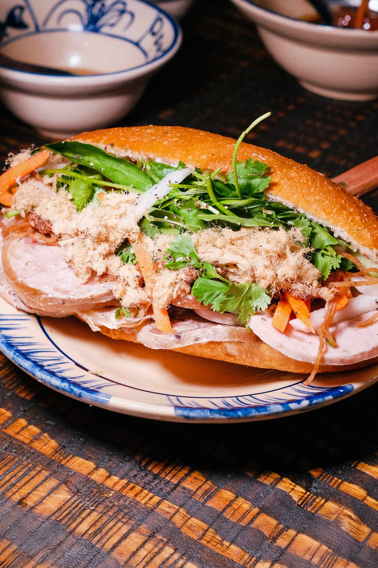 The O.G. bánh mì, stacked with beef, ham, Vietnamese head cheese, basil, cilantro, pickled carrots, daikon and pork floss. © Mr. David Eng/Bánh Anh Em