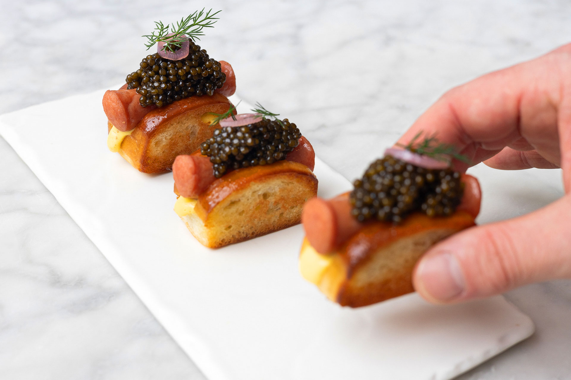 The Modern's caviar hot dogs are a decidedly upscale take. © Michelle Giang