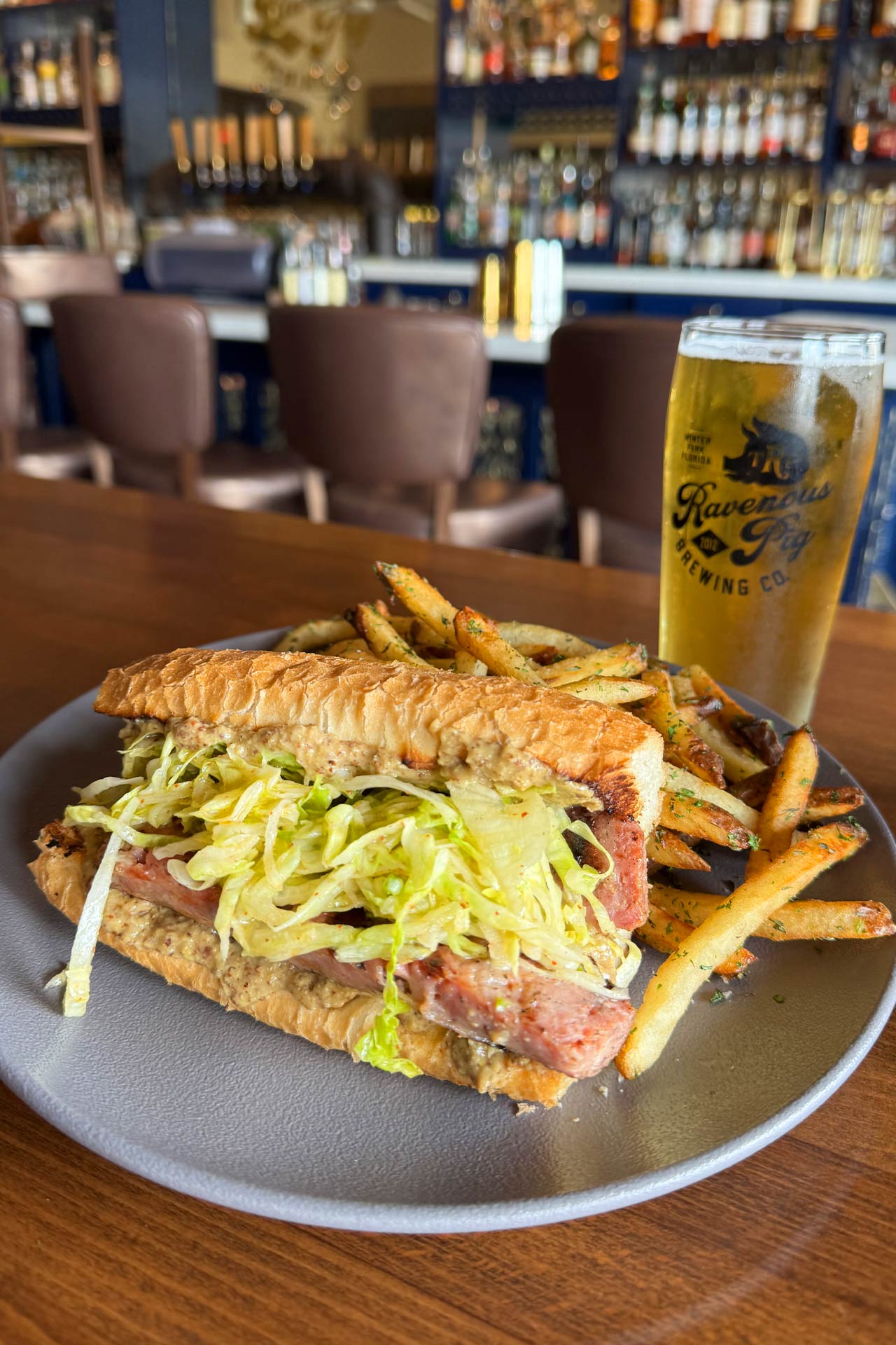 The cheddarwurst sandwich and an ice-cold beer is an unbeatable match at The Ravenous Pig. © The Ravenous Pig