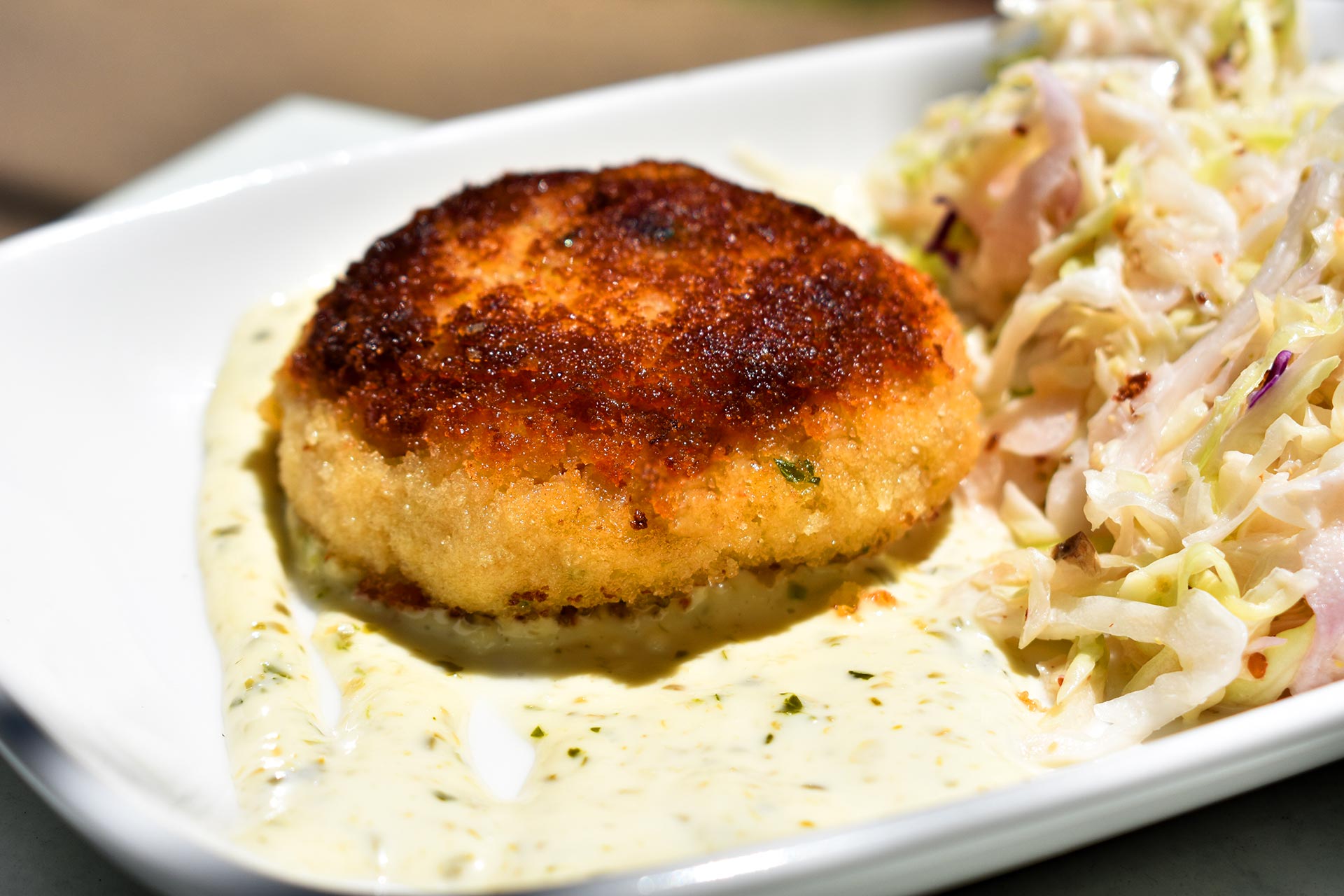 Crab cakes are a summertime signature. © Hank’s Oyster Bar