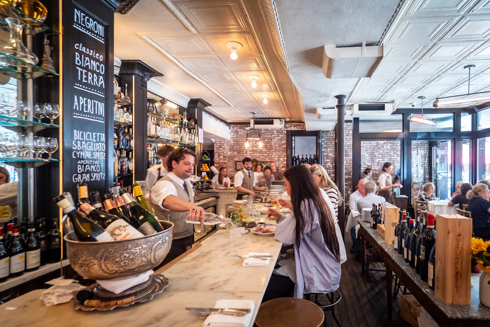Sit at Via Carota's bar and enjoy tonnarelli cacio e pepe and a signature negroni. © Thomas Robert Clarke Photography / MICHELIN Guide