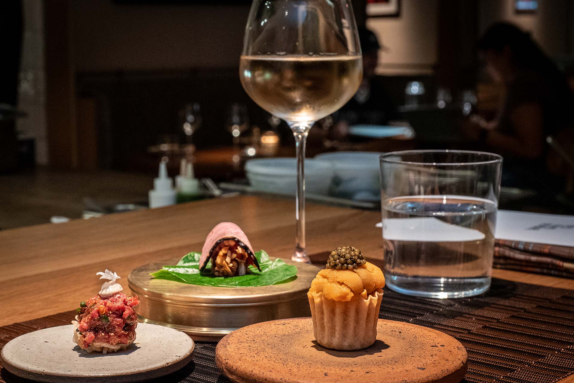 Bangkok Supper Club's tasting menu includes items like uni and crab tartlet, goi, and foie gras duck breast wrap. © Thomas Robert Clarke Photography / MICHELIN Guide